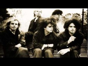 The Cure sitting on stairs in 1985. Black and white video still