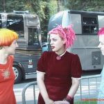 The ANtenna Girls with Pink and Orange hair in front of Tour busses